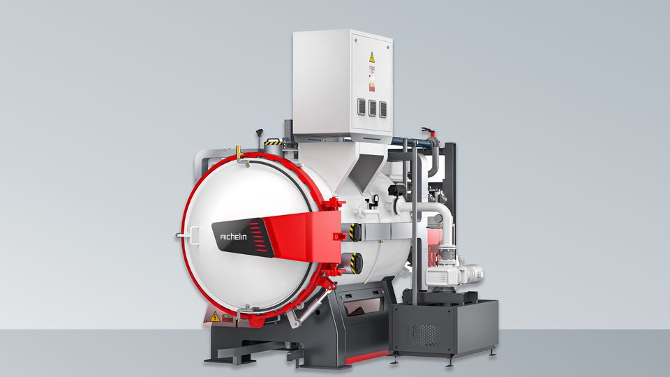 Industrial-scale vacuum furnace with control panel on top, featuring a large red and white chamber, set against a gradient gray background.